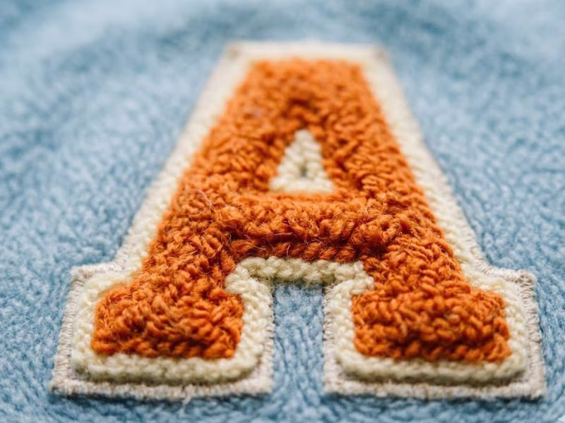 custom chenille patch with fuzzy moss-stitch texture.