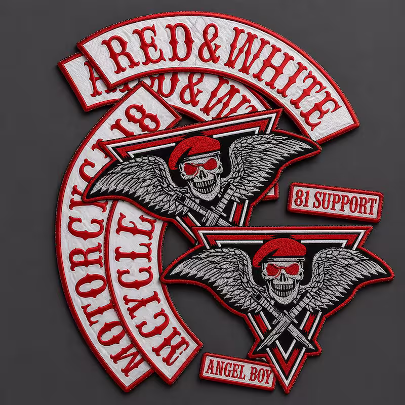 Embroidered motorcycle club patch set in red and white, including top rockers, winged skulls, and '81 Support' tags.