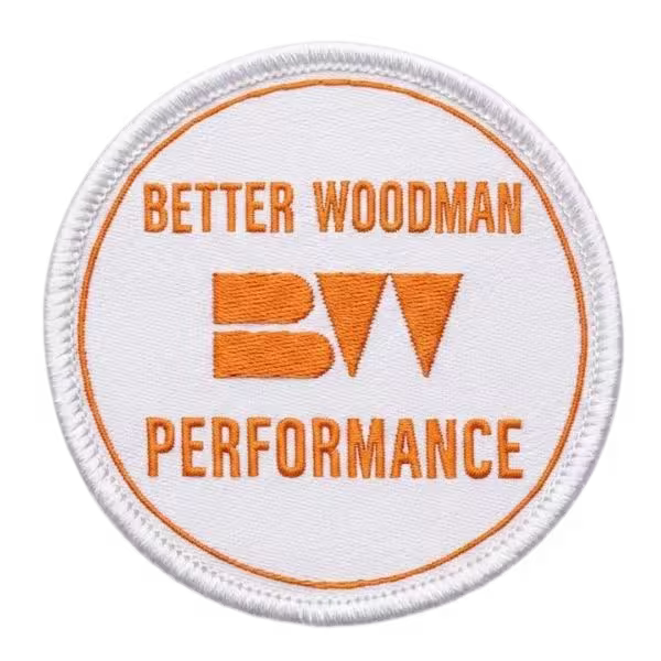 Flat profile custom woven patch with sharp orange lettering and clean merrowed edge.