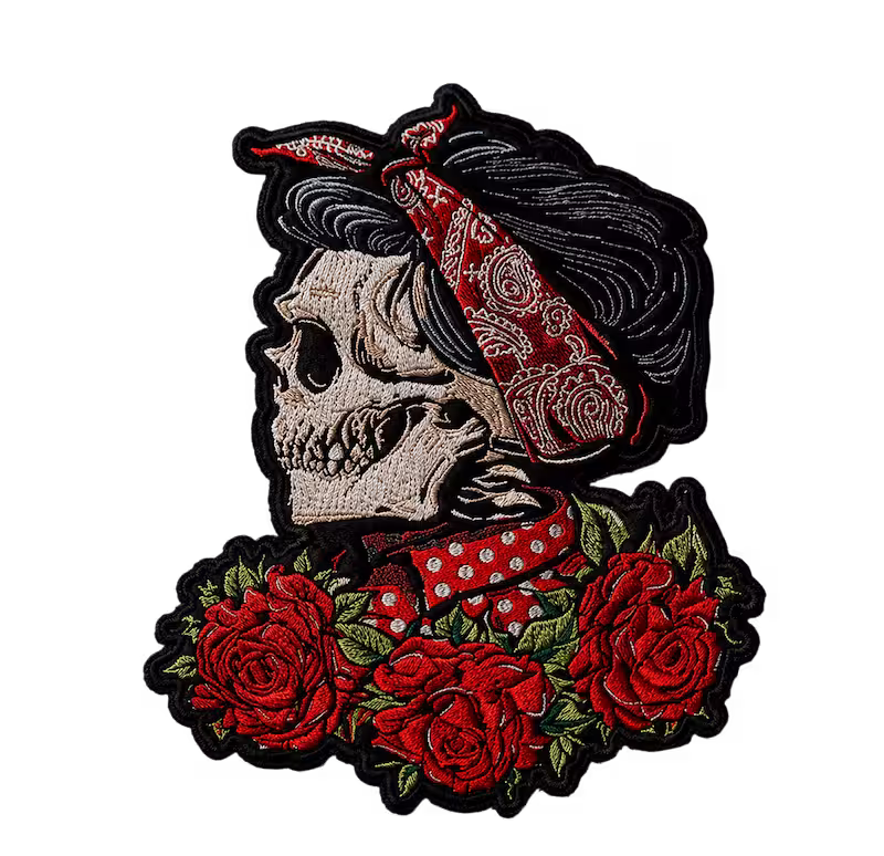 Embroidered patch of a female skull with black hair a red bandana and three red roses.