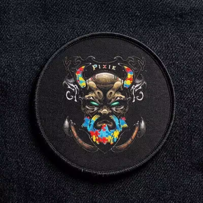 Detailed dye-sublimated circular patch showing sharp gradients and micro-text on a dark industrial twill background.