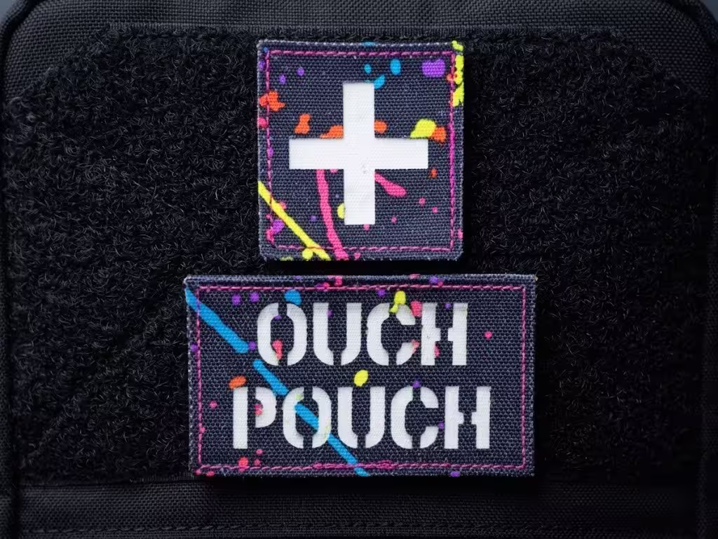 Neon paint-splattered medical cross and