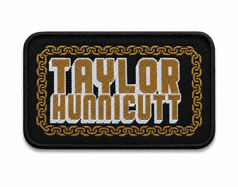Rectangular black woven patch featuring a gold chain border and Taylor Hunnicutt in layered bold text. 