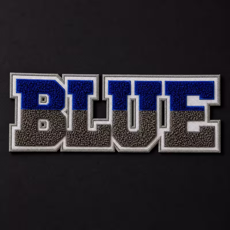 Custom chenille patch spelling BLUE in two tone blue and grey collegiate block letters